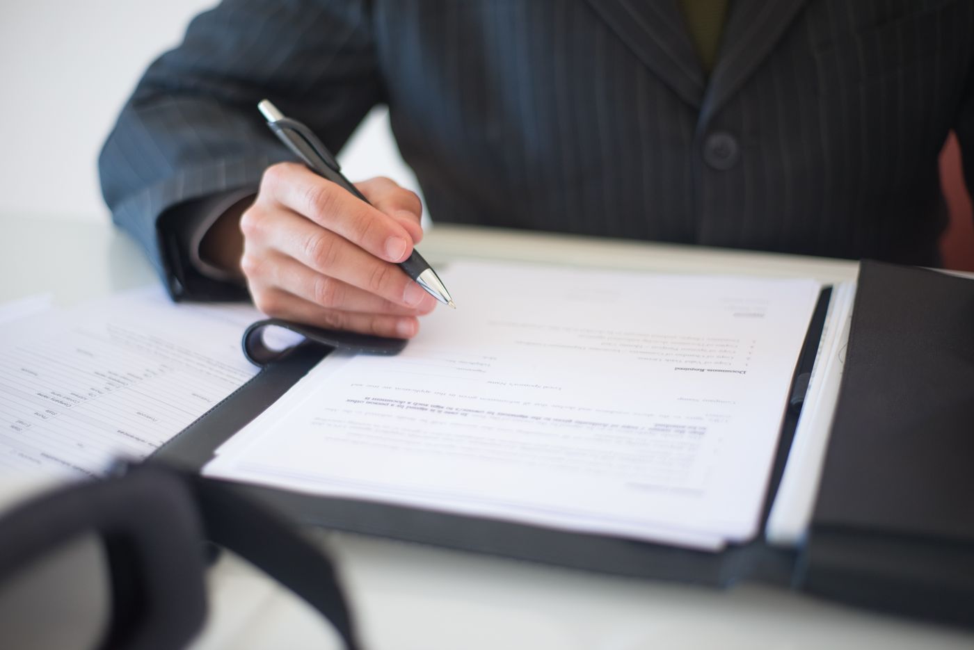 Signing a loan agreement with a pen