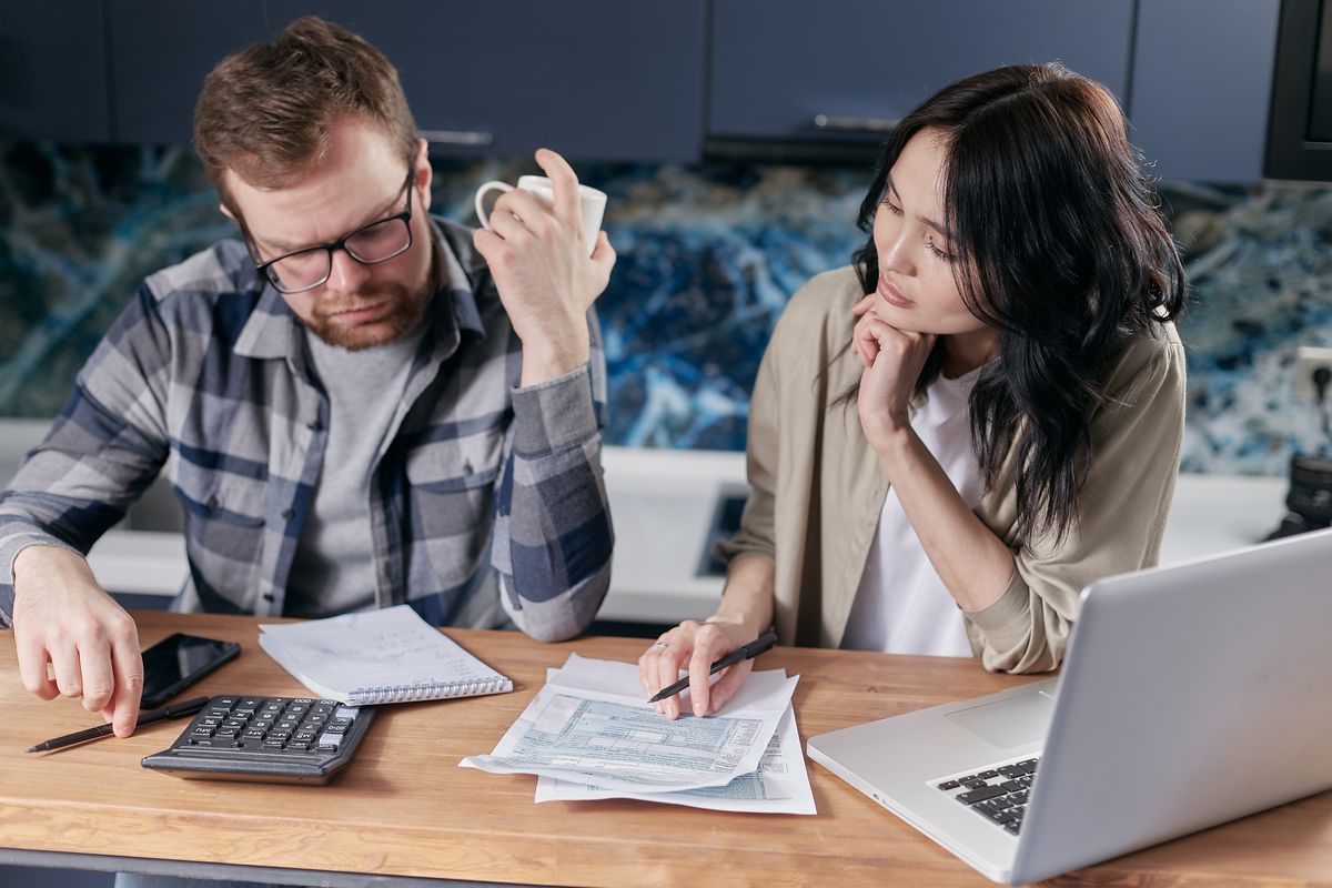 Couple reviewing household finances on a laptop
